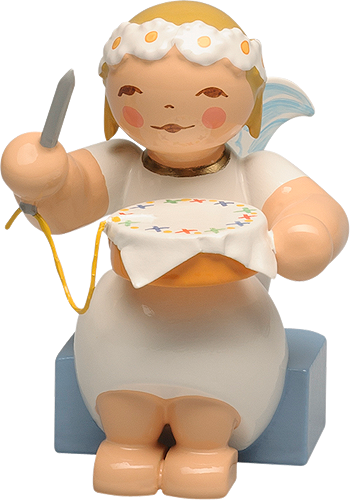 Marguerite Angel sitting with Embroidery Hoop