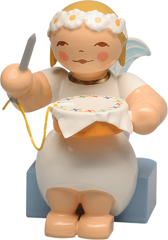 Marguerite Angel sitting with Embroidery Hoop