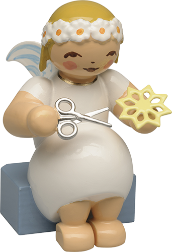 Marguerite Angel sitting with Paper Star