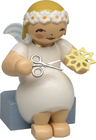 Marguerite Angel sitting with Paper Star