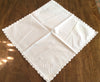 Placemats and Napkins:  White oval embroidered linen placemats set in rectangular border of French lace